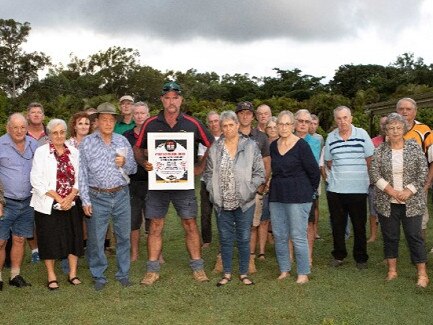 Mark Mason, centre (holding poster), with other concerned landholders and locals at therecent emergency meeting at Moorlands.