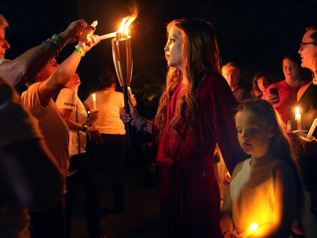 Elvis Presley’s daughter Lisa Marie lights the candles of fans who gathered at Graceland to commemorate the 40th anniversary of the singer’s death. Picture: Reuters