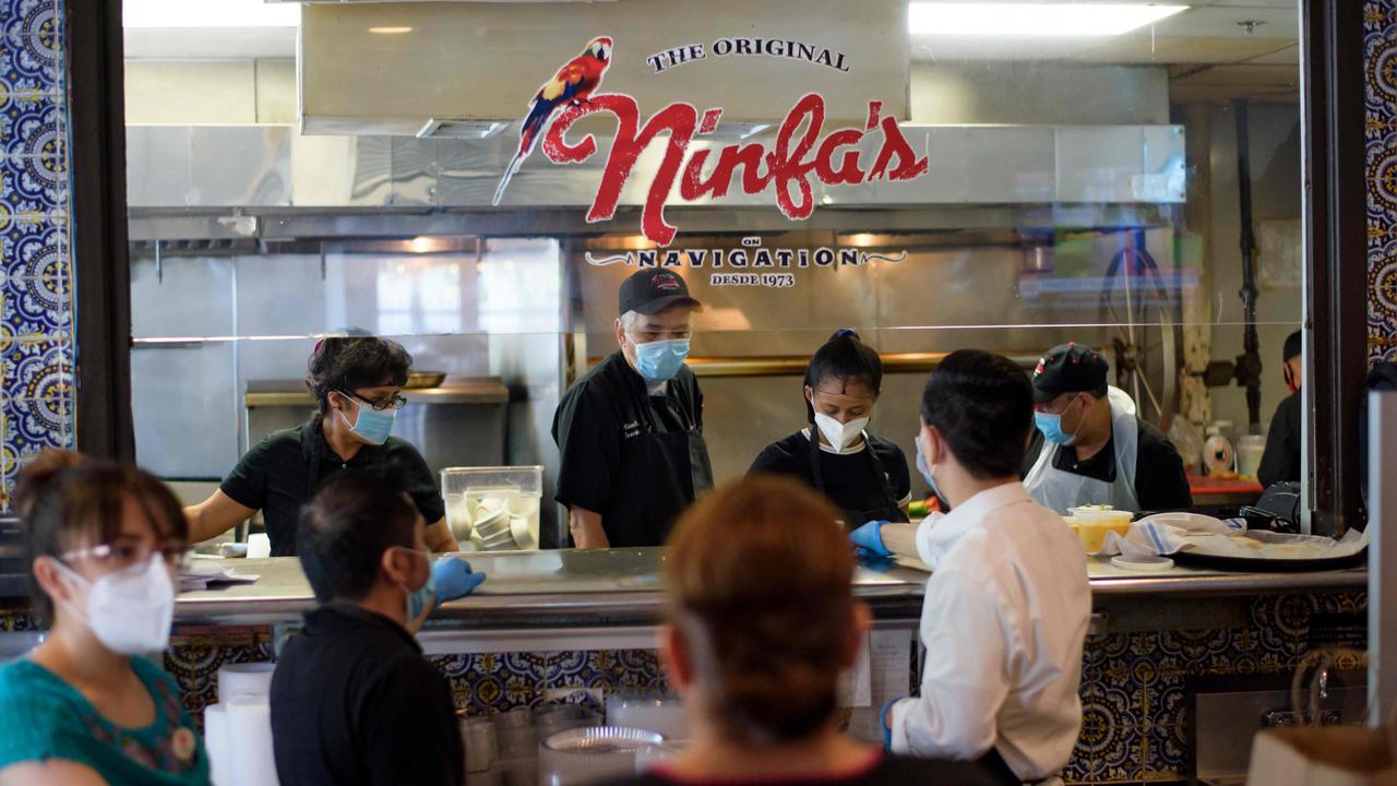 Servers at The Original Ninfa's. Texas on Friday became the largest US state to begin easing coronavirus lockdown measures despite reporting a single-day high in deaths. Picture: Mark Felix/AFP