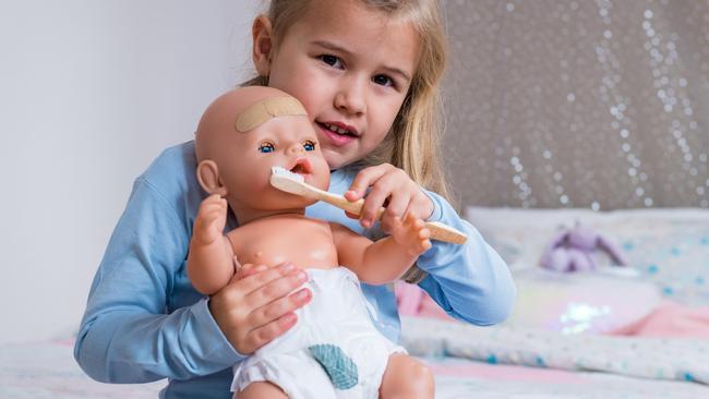 Asha, 4, uses eco-friendly products on her doll, including the bandaids, nappy and toothbrush. Picture: Jake Nowakowski