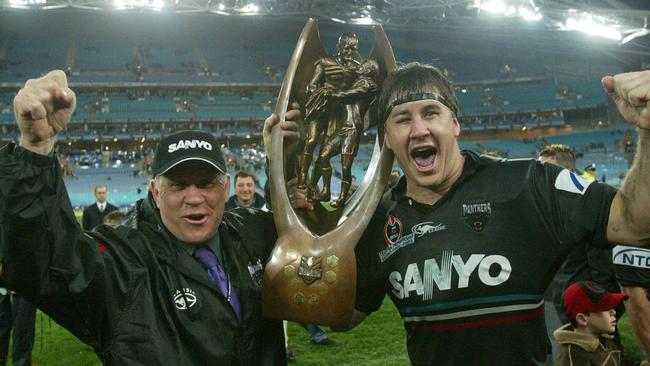 Family affair ... John and Martin Lang celebrate Penrith’s 2003 grand final win. Picture: Brett Costello. 