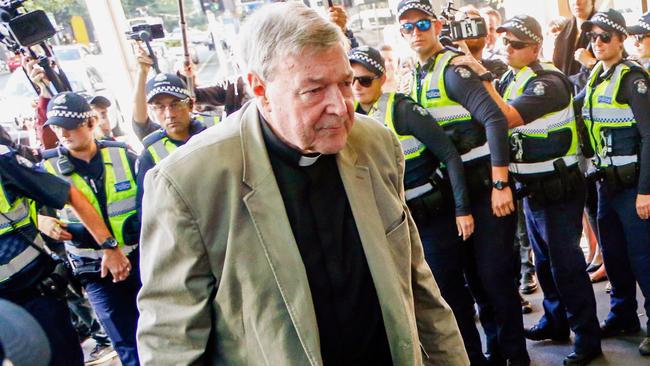 FILE - In this March 5, 2018, file photo, Cardinal George Pell arrives for a hearing at an Australian court in Melbourne, Australia. A lawyer for the most senior Vatican official ever charged in the Catholic Church sex abuse crisis told the Australian court on Tuesday, April 17, 2018 that Pell could have been targeted with false accusations to punish him for the crimes of other clerics. (AP Photo/Asanka Brendon Ratnayake, File)