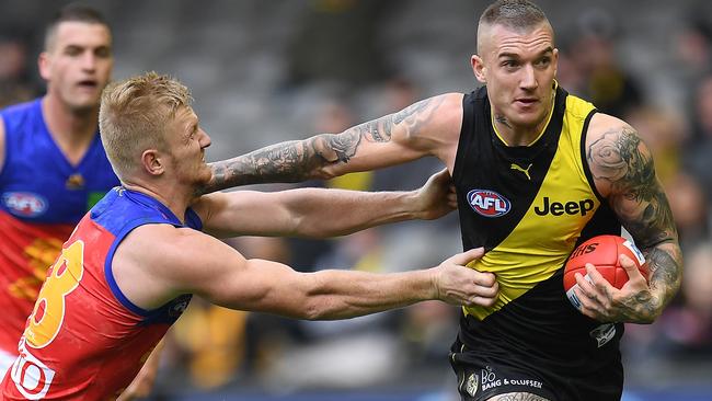 Dustin Martin of the Tigers (right) and Nick Robertson of the Lions contest during the Round 17 AFL match between the Richmond Tigers and the Brisbane Lions at Etihad Stadium in Melbourne, Sunday, July 16, 2017. (AAP Image/Julian Smith) NO ARCHIVING, EDITORIAL USE ONLY