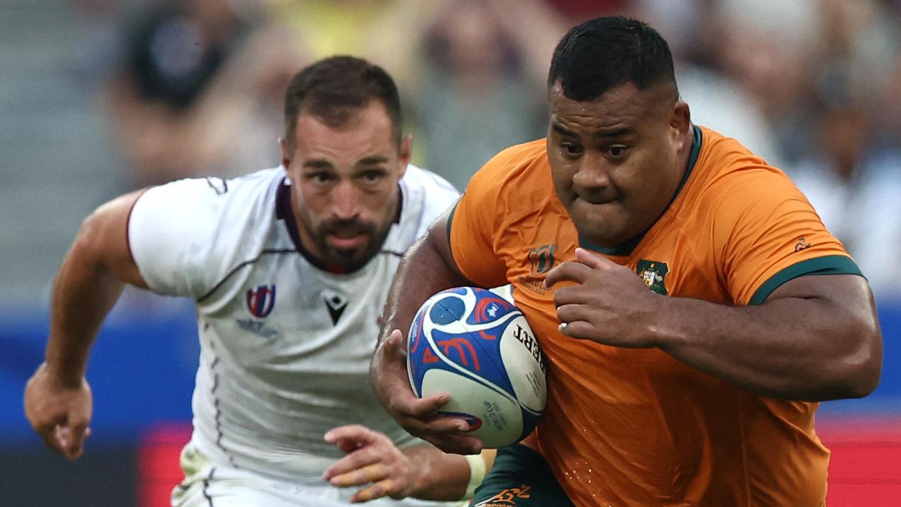 Australia's tighthead prop Taniela Tupou (R) runs with the ball during the France 2023 Rugby World Cup Pool C match between Australia and Georgia at Stade de France in Saint-Denis, on the outskirts of Paris, on September 9, 2023. (Photo by FRANCK FIFE / AFP)
