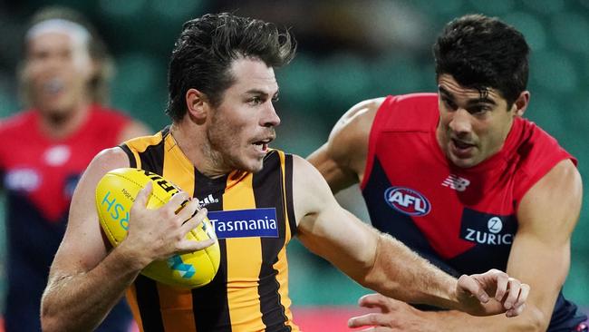 Christian Petracca of the Demons chases Isaac Smith of the Hawks during the AFL Marsh Community Series pre-season match between at UTAS Stadium in Launceston last month. Picture: AAP/MICHAEL DODGE