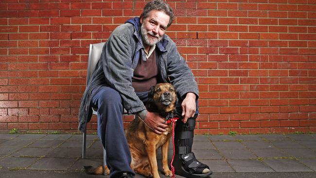 John Plumstead with 11 year old dog, Pippa as he has spent time at the safe night space and successfully moved on to be living in a house in South Hobart. Picture: Zak Simmonds