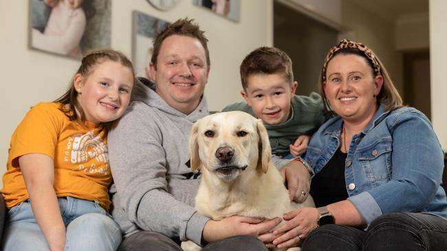 Archer, the blond labrador has won the cutest dog in Victoria Tim and Loren Parker with kids Keely, 10 and Elliott, 5 at their home in Cranbourne North. Picture: Jason Edwards