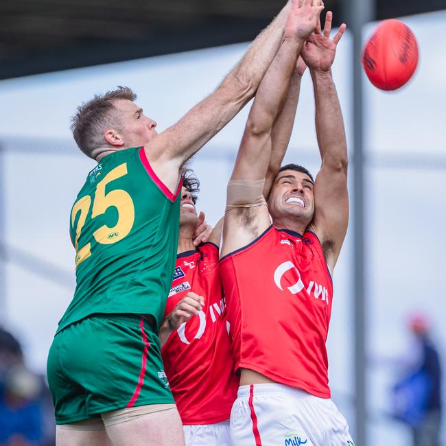 Tasmania's Sam Siggins battles for the ball with his Norwood opponents. Picture: Solstice Digital