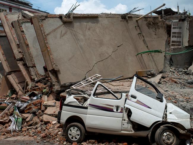 KATHMANDU, NEPAL - MAY 13: A crushed car amongst the rubble of destroyed buildings following a second major earthquake May 13, 2015 in Kathmandu, Nepal. A 7.3 magnitude earthquake struck in Nepal only two weeks after more than 8,000 people were killed in a devastating earthquake. The latest quake struck near Mt Everest near the town of Namche Bazar. Tremors were felt as far away as Bangladesh and Delhi. (Photo by Jonas Gratzer/Getty Images)