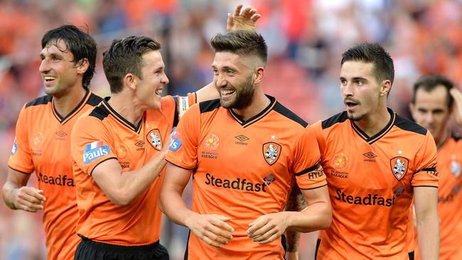 BRISBANE, AUSTRALIA - OCTOBER 18: Brandon Borrello of the Roar is congratulated by team mates Matt McKay (L) and Jamie Maclaren (R) after scoring a goal during the round two A-League match between the Brisbane Roar and Central Coast Mariners at Suncorp Stadium on October 18, 2015 in Brisbane, Australia. (Photo by Bradley Kanaris/Getty Images)