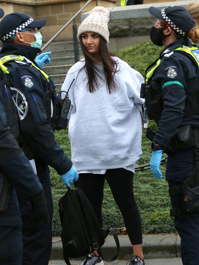 Police speak with a protester. Picture: Matrix