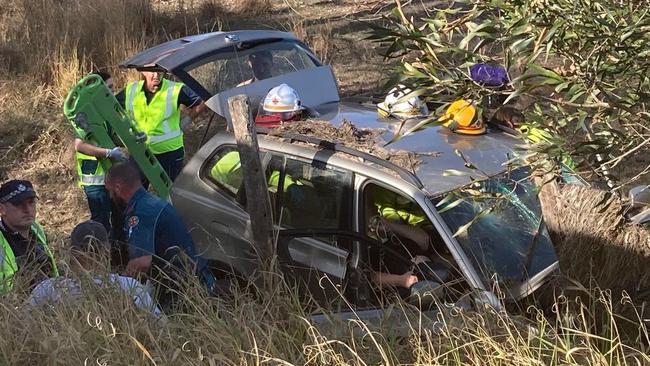 Driver trapped after car rolls over embankment