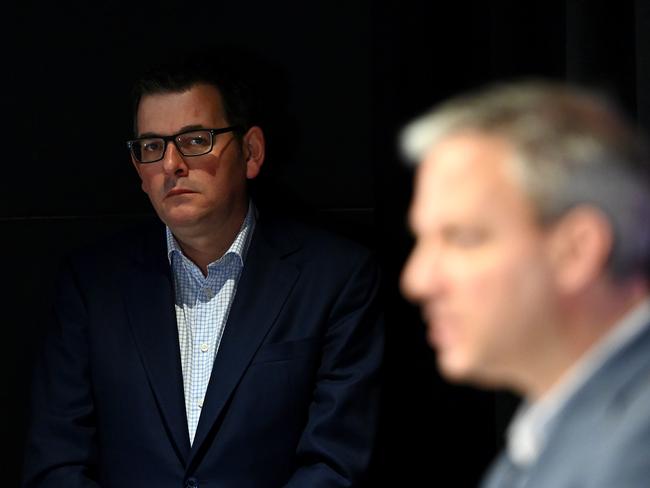 MELBOURNE, AUSTRALIA - JULY 13: Victorian Premier Daniel Andrews watches on as Victoria's Chief Health Officer Professor Brett Sutton speaks to the media at a press conference at Treasury Theatre on July 13, 2020 in Melbourne, Australia. Metropolitan Melbourne and the Mitchell shire are in lockdown following the rise in COVID-19 cases through community transmissions. The new restrictions came into effect on Thursday 9 July, with residents in lockdown areas under stay at home orders for the next six weeks. People are only able to leave home have for exercise or work, to buy essential items including food or to access childcare and healthcare. Gatherings of groups of more than two or more than a household group are not permitted while school holidays have been extended by a week so children remain home. Retail can remain open and markets are permitted to open for food and drink only. Cafes, restaurants, pubs, clubs and bars are back to takeaway only. Eight public housing estates that have been under hard lockdown have reopened subject to stage 3 COVID-19 restrictions in line with the rest of Melbourne, while the tower at Alfred Street remains under hard lockdown while health authorities continue COVID-19 testing. (Photo by Quinn Rooney/Getty Images)