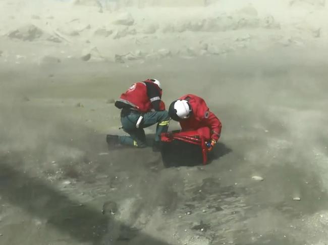 Rescuers arrive on White Island after the volcano eruption. Picture: Auckland Rescue Helicopter Trust