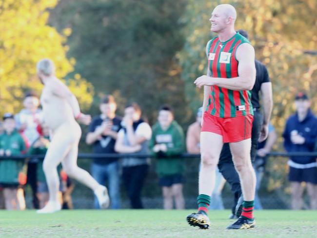 Moments earlier, the streaker takes off with Barry Hall in his sights. Picture: Alex Coppel