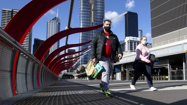 Melburnians stroll around a deserted Docklands precinct during stage 4 lockdowns. Picture: David Geraghty