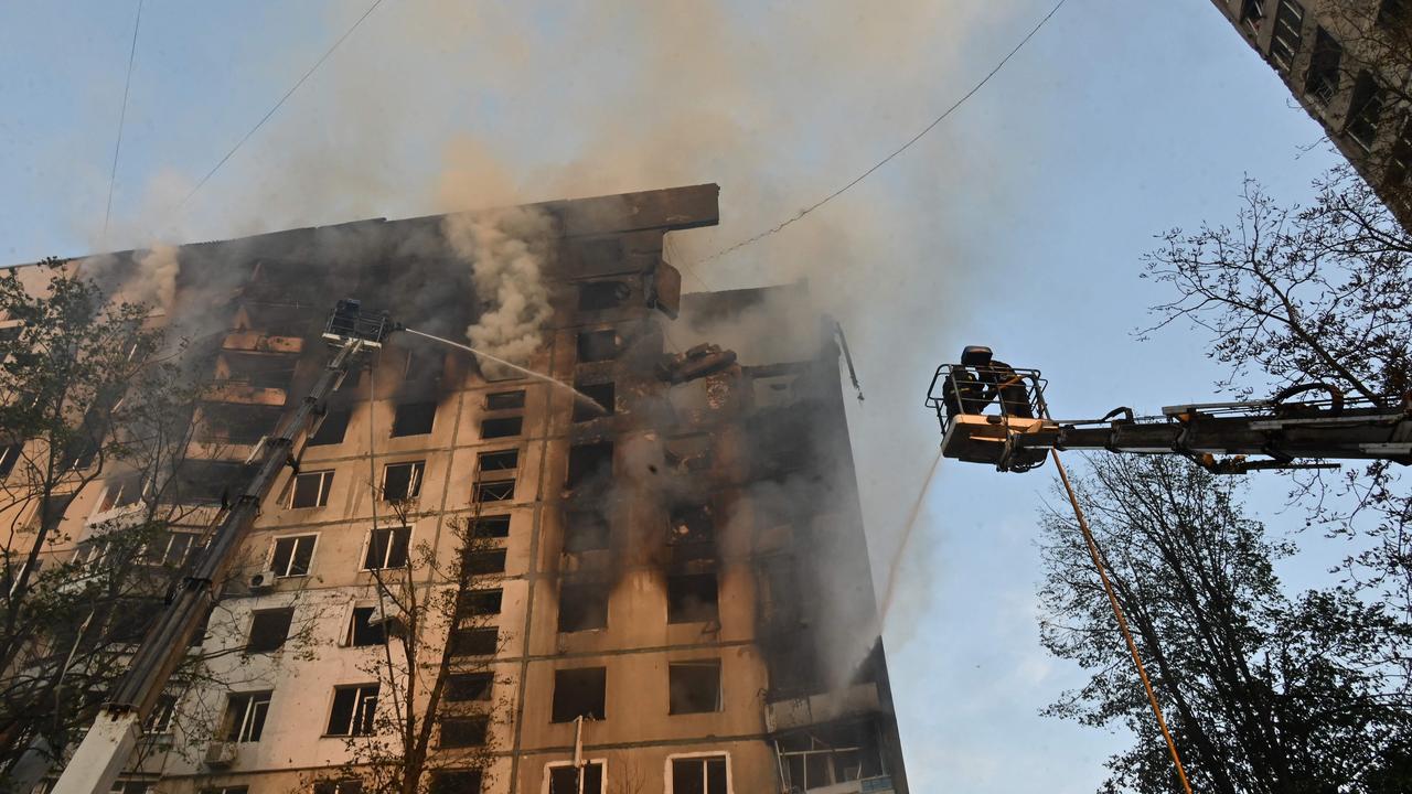 Ukrainian rescuers work to extinguish a fire in a residential building in Kharkiv. Picture: Sergey Bobok/AFP