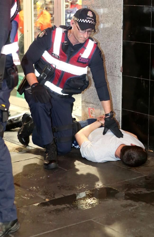 A youth lies on the ground not far from Flinder Street station. Picture Yuri Kouzmin