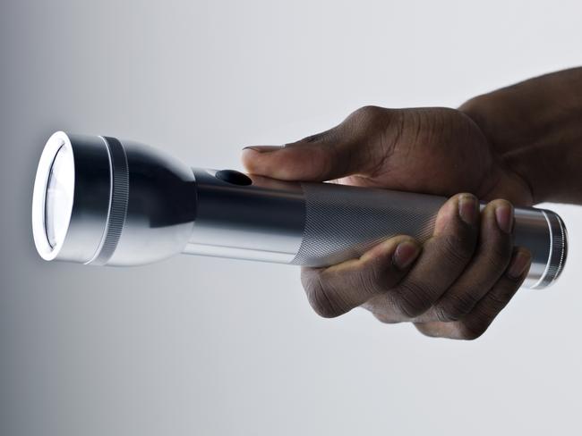 General view generic stock iStock image of hand holding torch flashlight. Picture: iStock