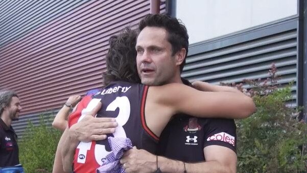 Former Essendon great Gavin Wanganeen embraces his son Tex after his signing to the club as a rookie.