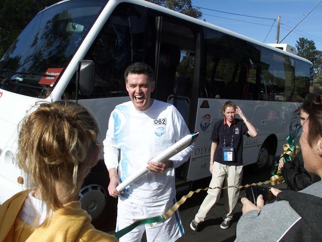 Olympic Torch Relay Day 89: September 04, 2000, Penrith to Bowral. NSW Olympics Minister Michael Knight transfers his flame in Campbelltown today. Picture: Glen Campbell