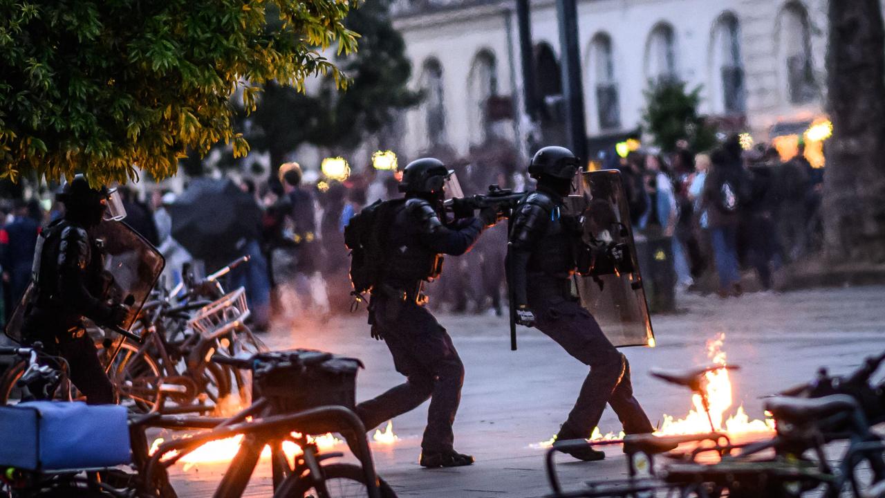 Anti riot police officers received a molotov cocktail during a demonstration. Picture: Loic Venance / AFP