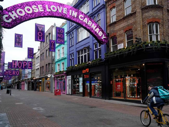 A cyclist rides down a near-deserted Carnaby Street in London on Boxing Day.