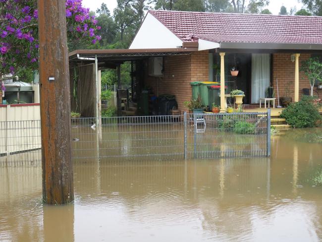 Flooding on Geoffrey Rd, Chittaway, after torrential rain over the weekend. Picture: Richard Noone