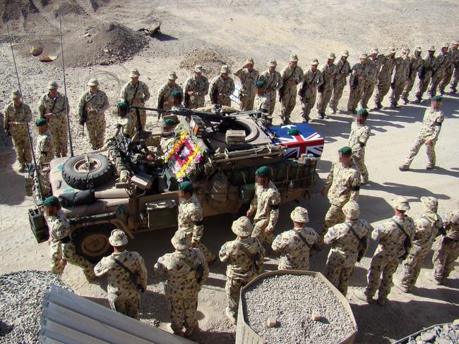 Special Operations Task Group troops escort a patrol vehicle carrying the casket of SAS commando Lance Corporal Jason Marks during a Ramp Ceremony at their base in Oruzgan Province, southern Afghanistan.