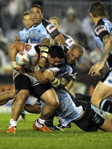 <p>NRL round 15 Sharks v Warriors: Konrad Hurrell is swamped by Sharks players. Picture: Rohan Kelly.</p>