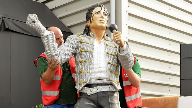 A group of stonemasons remove the statue of Michael Jackson from Fulham’s home ground.
