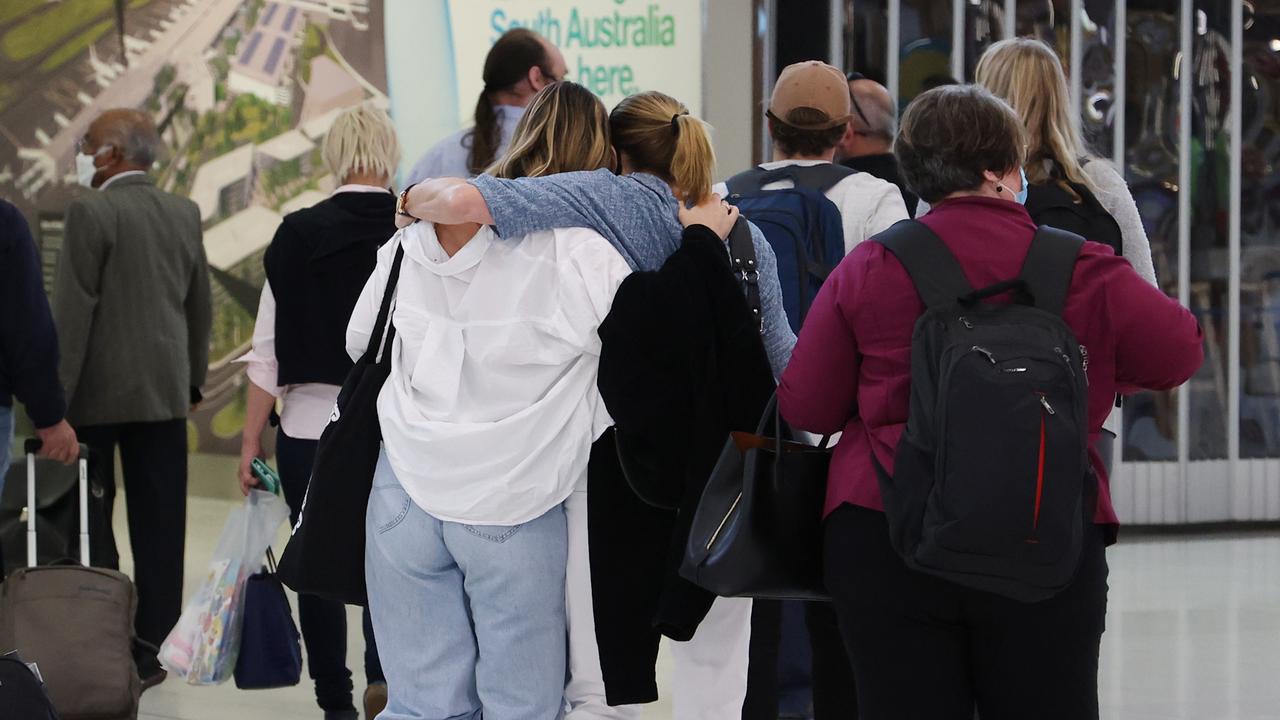 People reunite at Adelaide Airport on the first day of the border opening. Picture: NCA NewsWire / David Mariuz
