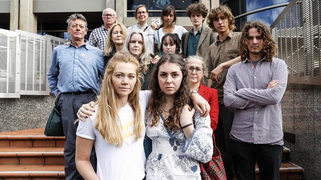 Extinction Rebellion activists (front) Claire Burgess and Stella McGill alongside fellow activists who attended Hobart Magistrates Court today after being charged for last year's protest in the CBD. Picture: Zak Simmonds