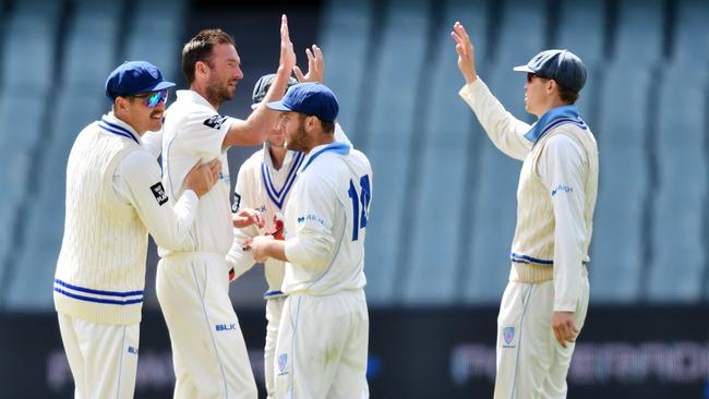 NSW players celebrate the dismissal of SA’s Nick Winter during the first session on day four of the Sheffield Shield clash at Adelaide Oval. AAP Image/David Mariuz