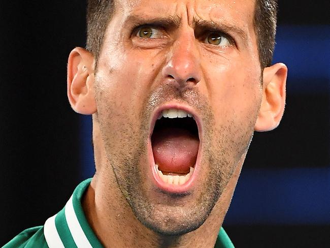 (FILES) This file photo taken on February 12, 2021 shows Serbia's Novak Djokovic reacting after a point against Taylor Fritz of the US during their men's singles match on day five of the Australian Open tennis tournament in Melbourne. - Novak Djokovic lost his bid to avoid deportation from Australia on January 16, 2022, with a Federal Court unanimously rejecting his appeal to stay in the country and defend his Australian Open title. (Photo by William WEST / AFP) / -- IMAGE RESTRICTED TO EDITORIAL USE - STRICTLY NO COMMERCIAL USE --