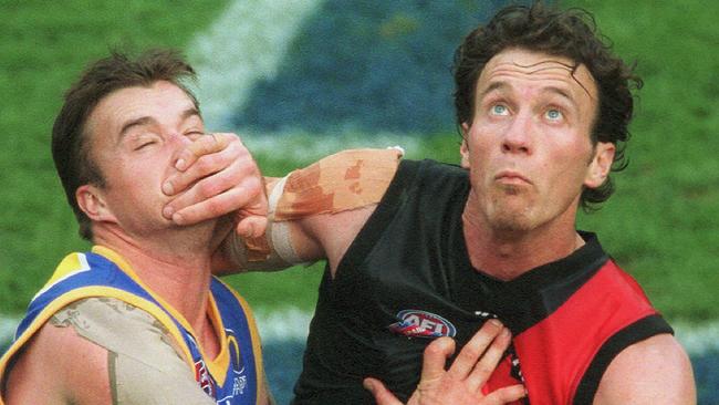 Steven Alessio locks horns with Clark Keating in the 2001 AFL grand final.