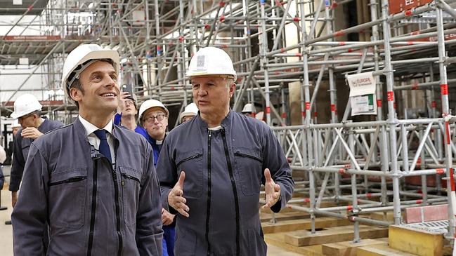 French Army General Jean-Louis Georgelin, right, leads the visit of French President Emmanuel Macron at the reconstruction site inside the Notre-Dame Cathedral on April 15, 2022, during a visit to mark the third anniversary of the fire. Picture: Ian Langsdon/Pool/AFP