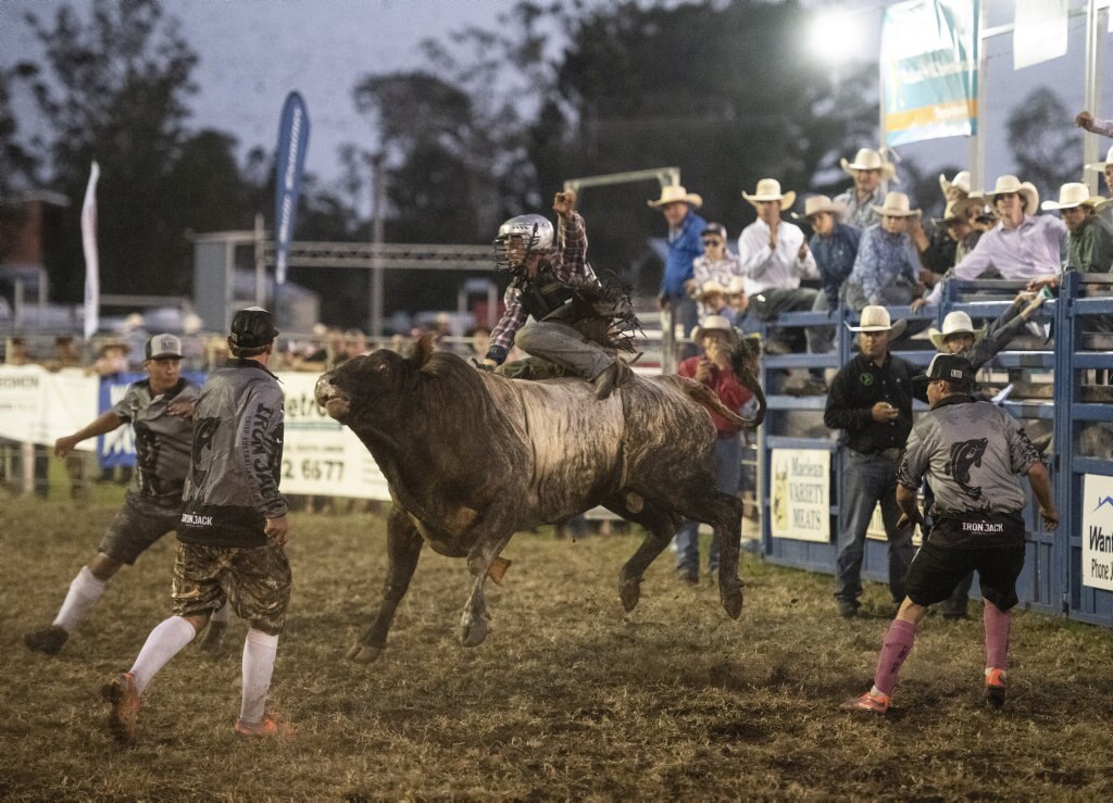 Ethan McConnell gets a rough ride in the open bullride at the Lawrence Twilight Rodeo. Picture: Adam Hourigan