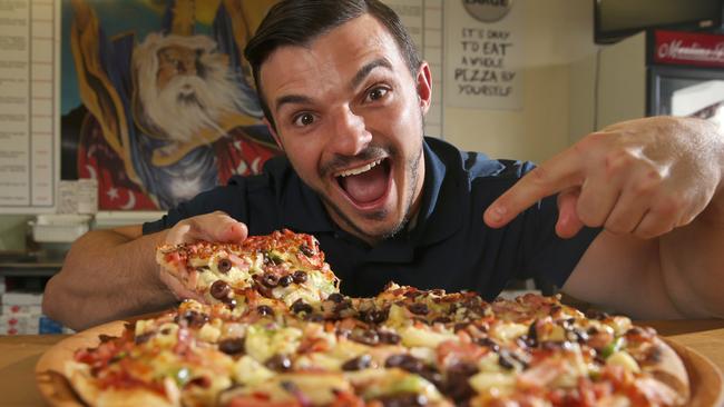 Scott Jelich of Merlins Pizza with Excallibur, one of their signature pizza. Photo: Regi Varghese