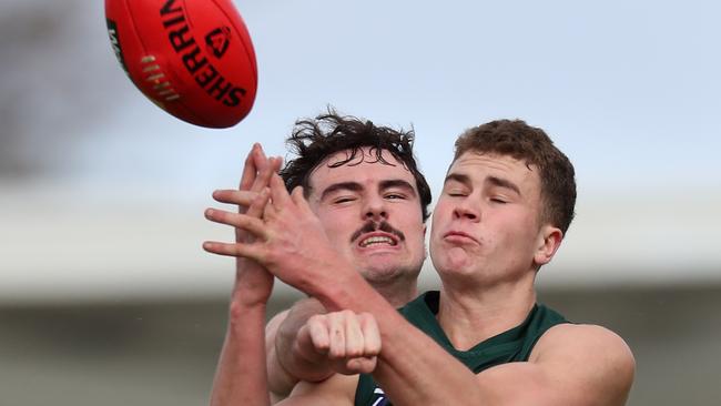 Ballarat’s Kyle Borg tries to prevent Hampden’s Hamish Cook from taking the mark. Picture Yuri Kouzmin