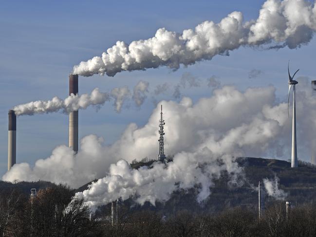 FILE --- This Jan. 16, 2020 file photo shows a Uniper energy company coal-fired power plant and a BP refinery beside a wind generator in Gelsenkirchen, Germany. The German government is to agree its national hydrogen strategy for the coming decades, part of a plan to reduce the country's dependence on fossil fuels. (AP Photo/Martin Meissner, file)