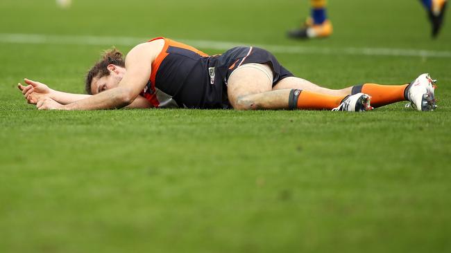 SYDNEY, NEW SOUTH WALES — MAY 12: Phil Davis of the Giants lies injured on the ground during the round eight AFL match between the Greater Western Giants and the West Coast Eagles at Spotless Stadium on May 12, 2018 in Sydney, Australia. (Photo by Mark Kolbe/Getty Images)