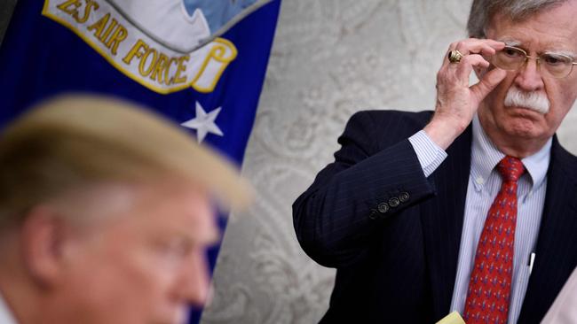 Former national Security Advisor John Bolton listens while US President Donald Trump speaks to the press before a meeting with Hungary's Prime Minister Viktor Orban in the Oval Office in 2019.