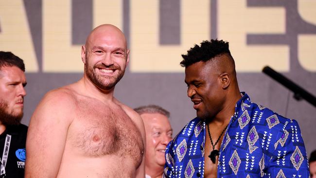 Tyson Fury (left) and Francis Ngannou react in the face off during a press conference ahead of Sunday’s heavyweight clash.