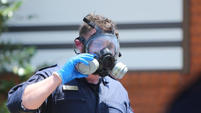 A NSW Fire and Rescue worker in a protective breathing mask. Picture: Tim Hunter