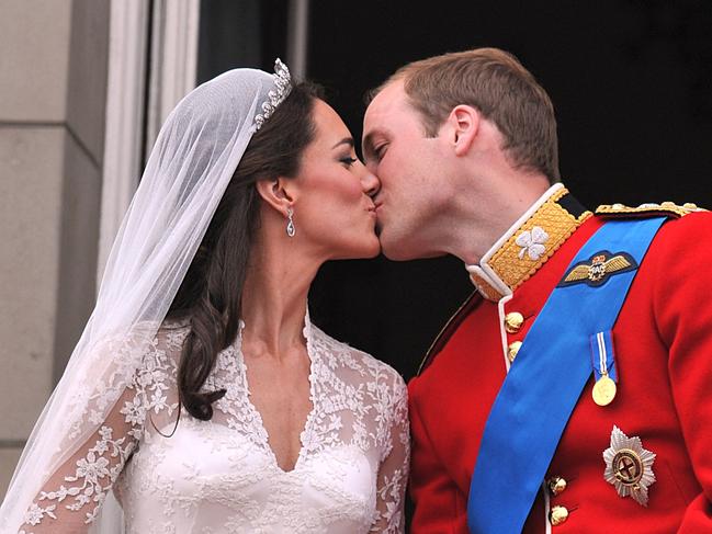 Princess Catherine and Prince William kiss on the balcony of Buckingham Palace following their wedding on April 29, 2011. Picture: AFP