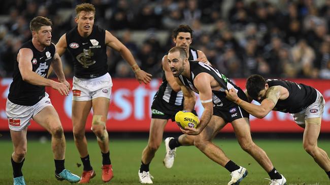 Steele Sidebottom tries to break a tackle as Carlton adopted more defensive tactics against Collingwood last weekend. Picture: AAP