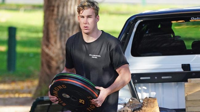 Tom Lynch returns weights to the Tigers clubrooms at Punt Road Oval.