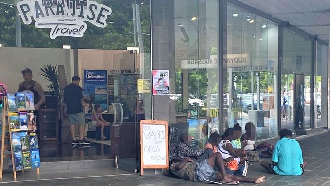 A group of itinerants on the footpath outside a business at the corner of Lake and Shields streets in the Cairns CBD. Picture: Supplied