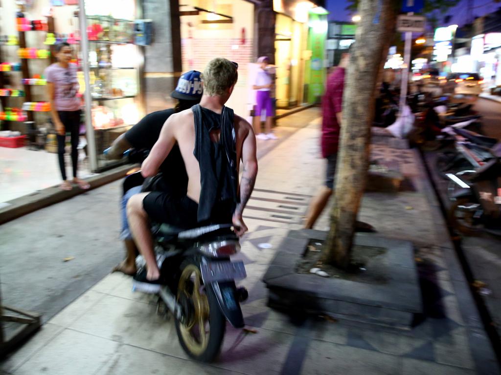 Bali: A schoolie rides on the footpath to avoid traffic on a bust Kuta street. Picture: Nathan Edwards